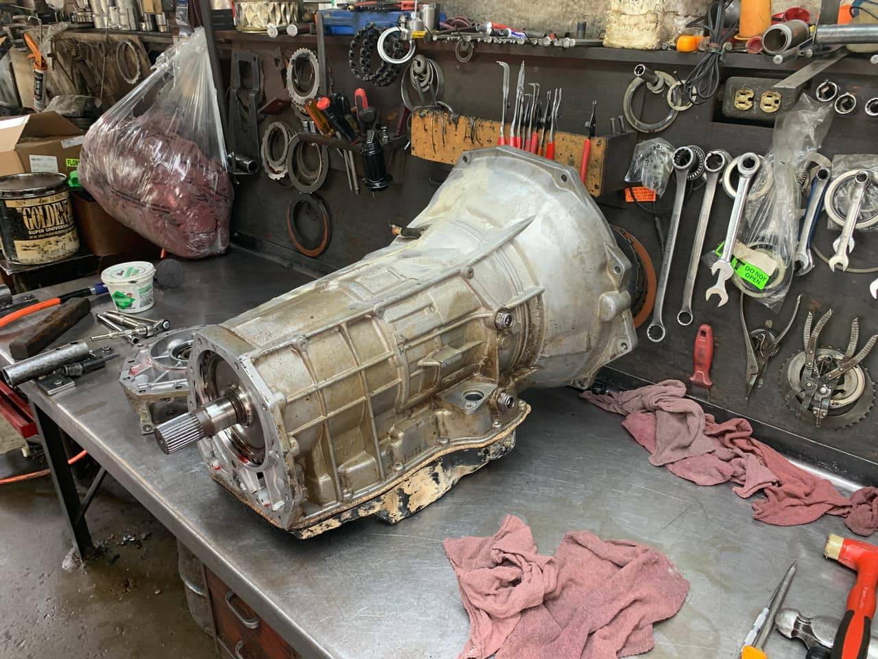 Technician installing a replacement transmission on a customer vehicle in Cleburne, TX